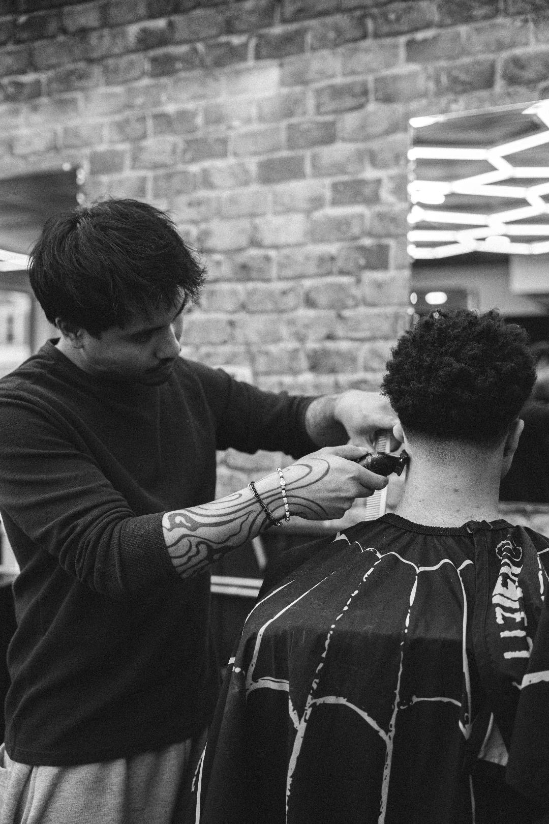 Adrien cutting hair at Section Five-O-Six
