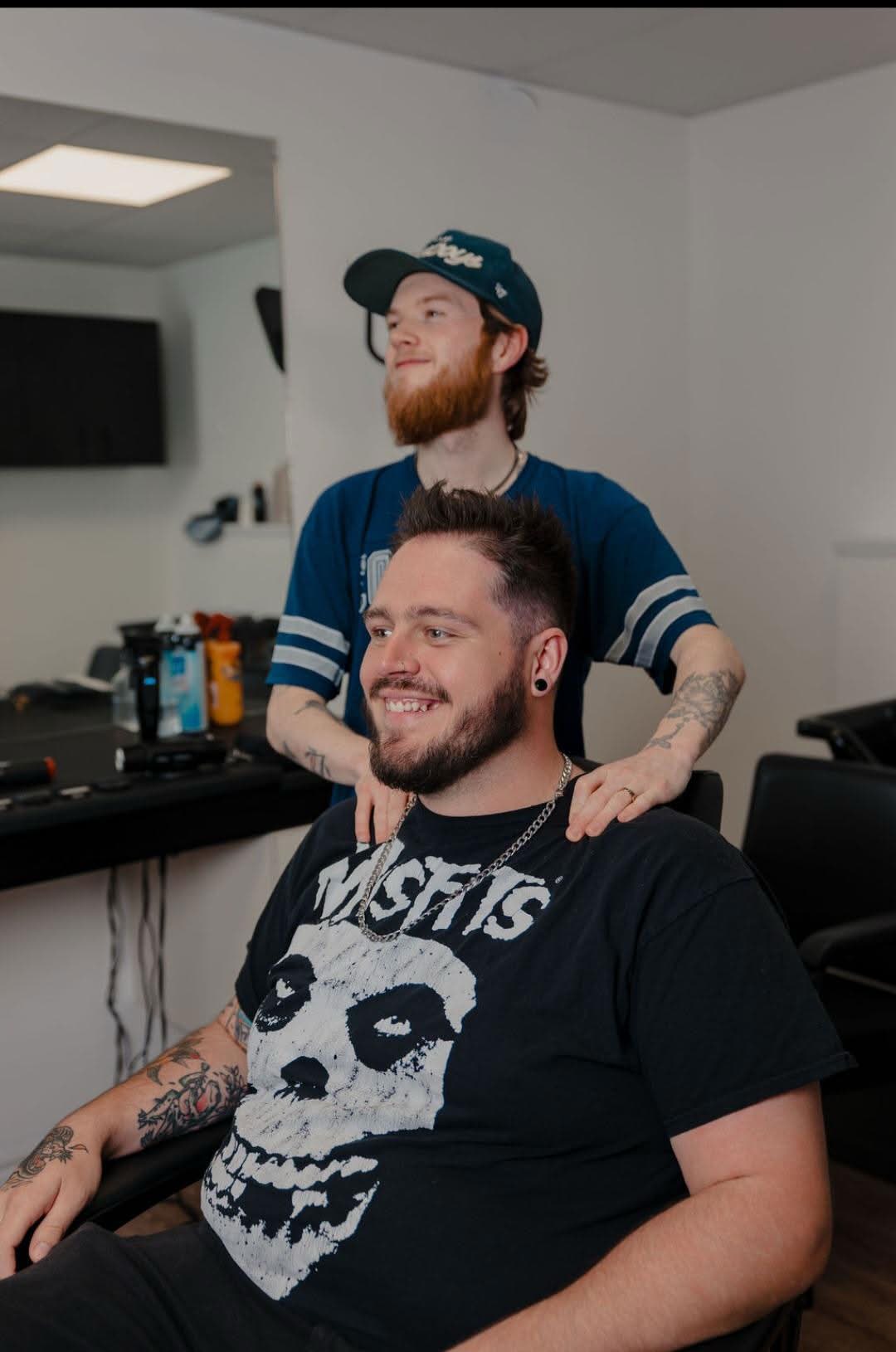 Owen finishing a cut on Talon in the barber chair