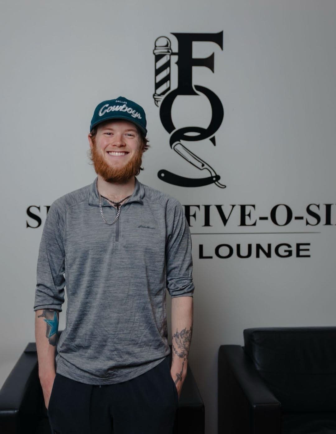 Owen in front of the Section Five-O-Six wall