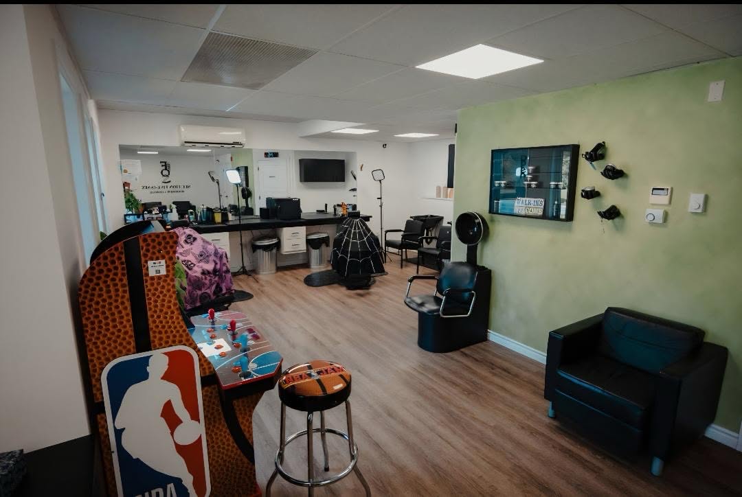 The lounge, arcade cabinet and green accent wall