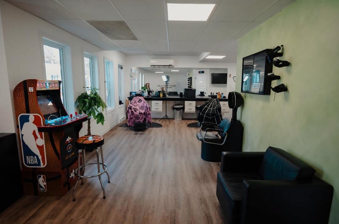 The full length of the lounge, arcade cabinet to waiting chairs
