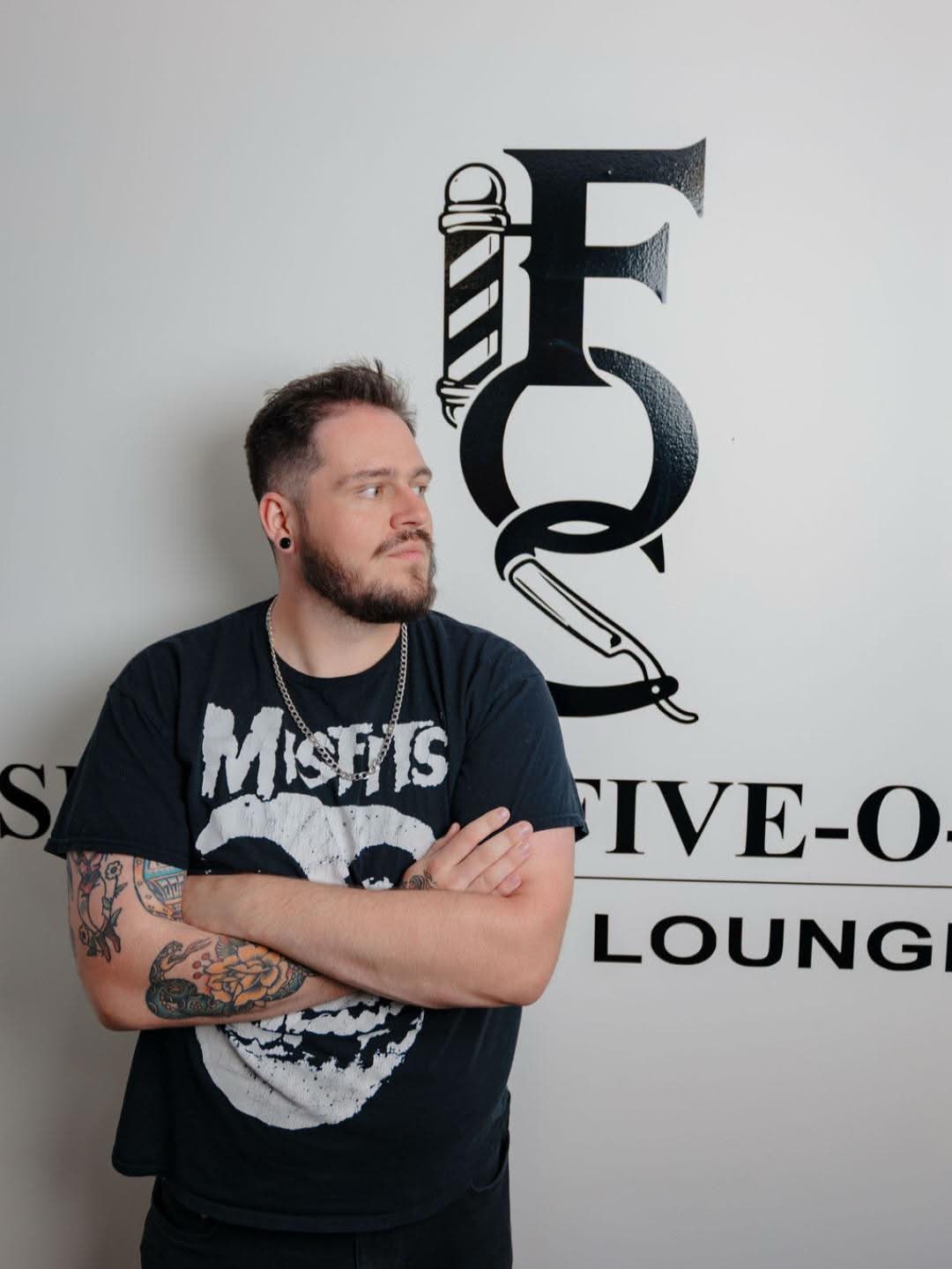Talon in front of the Section Five-O-Six logo wall